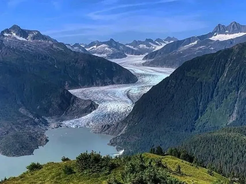 Ridge view of deep blue crevasses and icefall at the end of a West Glacier Trail guided hike to the face of Mendenhall Glacier near Juneau