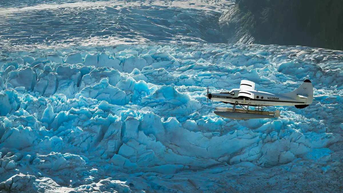 Floatplane flying over crevassed ice of the Juneau Icefield on a 5-glacier flightseeing tour near Mendenhall Glacier
